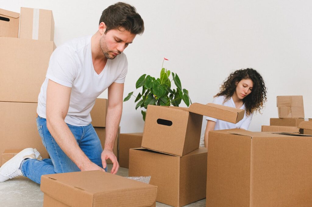 pexels photo 7203889 A young couple unpacks boxes in their new home, creating a cozy space together.